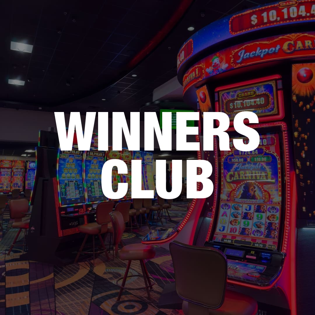 A casino's Winners Club area with slot machines and neon lights ...
