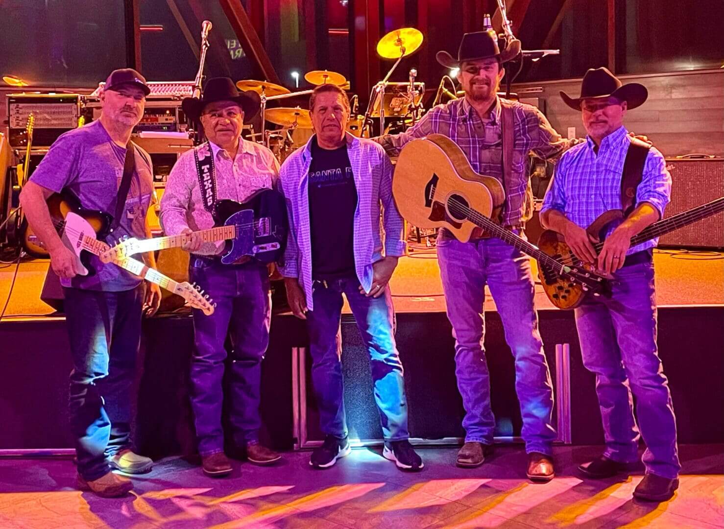 Five men with instruments in cowboy hats.
