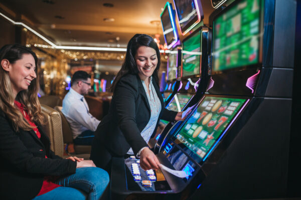 Casino worker helps on slot machines
