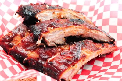 Barbecue ribs on red checkered paper.