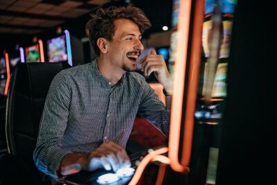 Slot machine player laughing in a casino