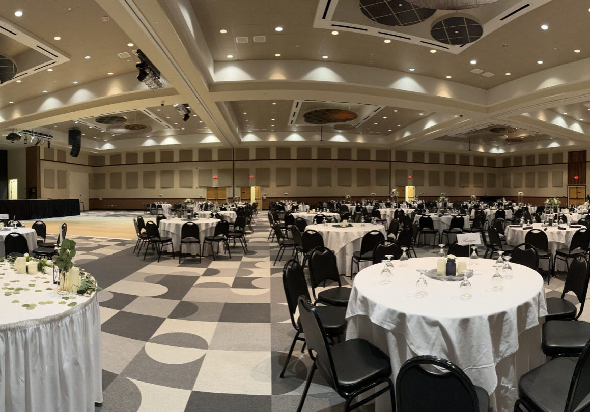 A large banquet hall with tables and chairs.